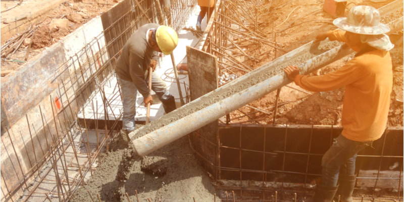 Workers were pouring concrete foundations for buildings